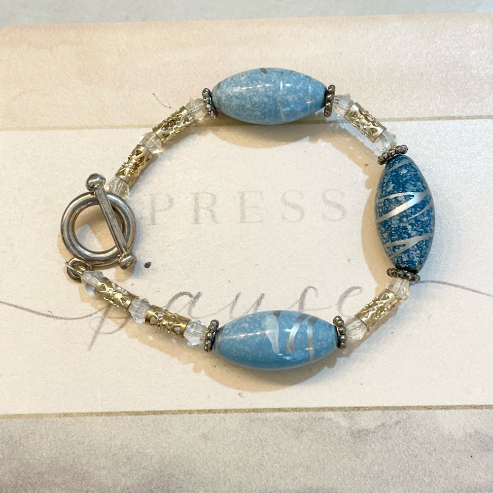 Handcrafted, blue bead and silver colored bracelet